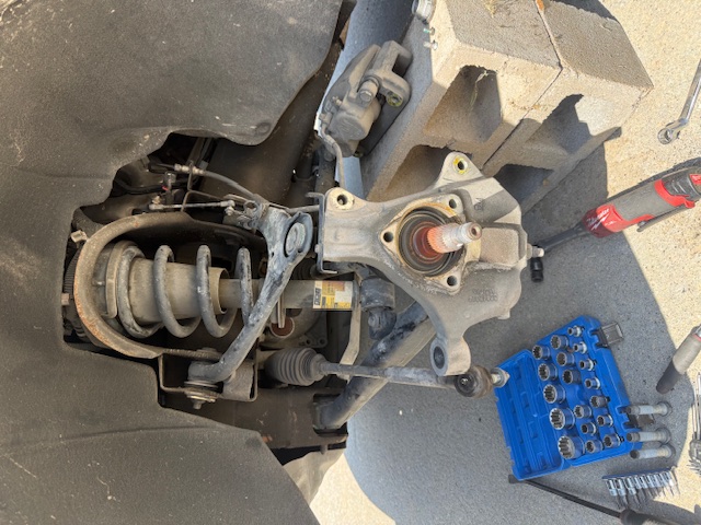 Mechanic working on suspension and shock components